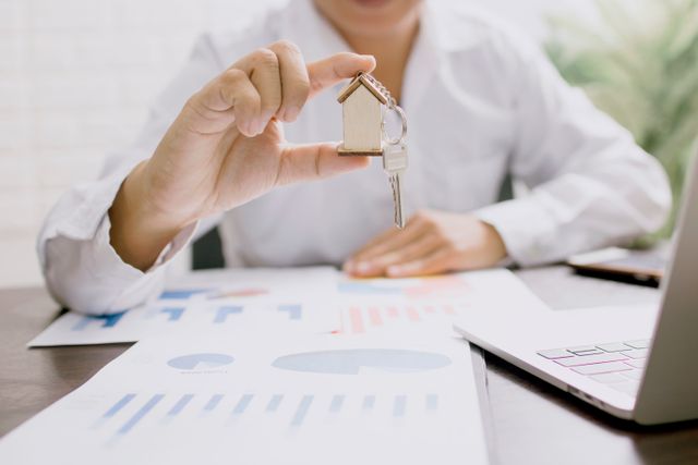 a property manager holding a key to a rental property